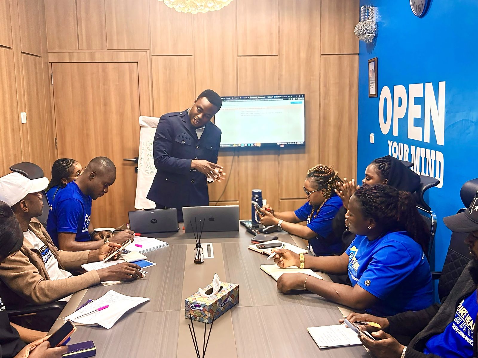 Tion Joseph leading a corporate digital marketing strategy session with a leadership team in Abuja