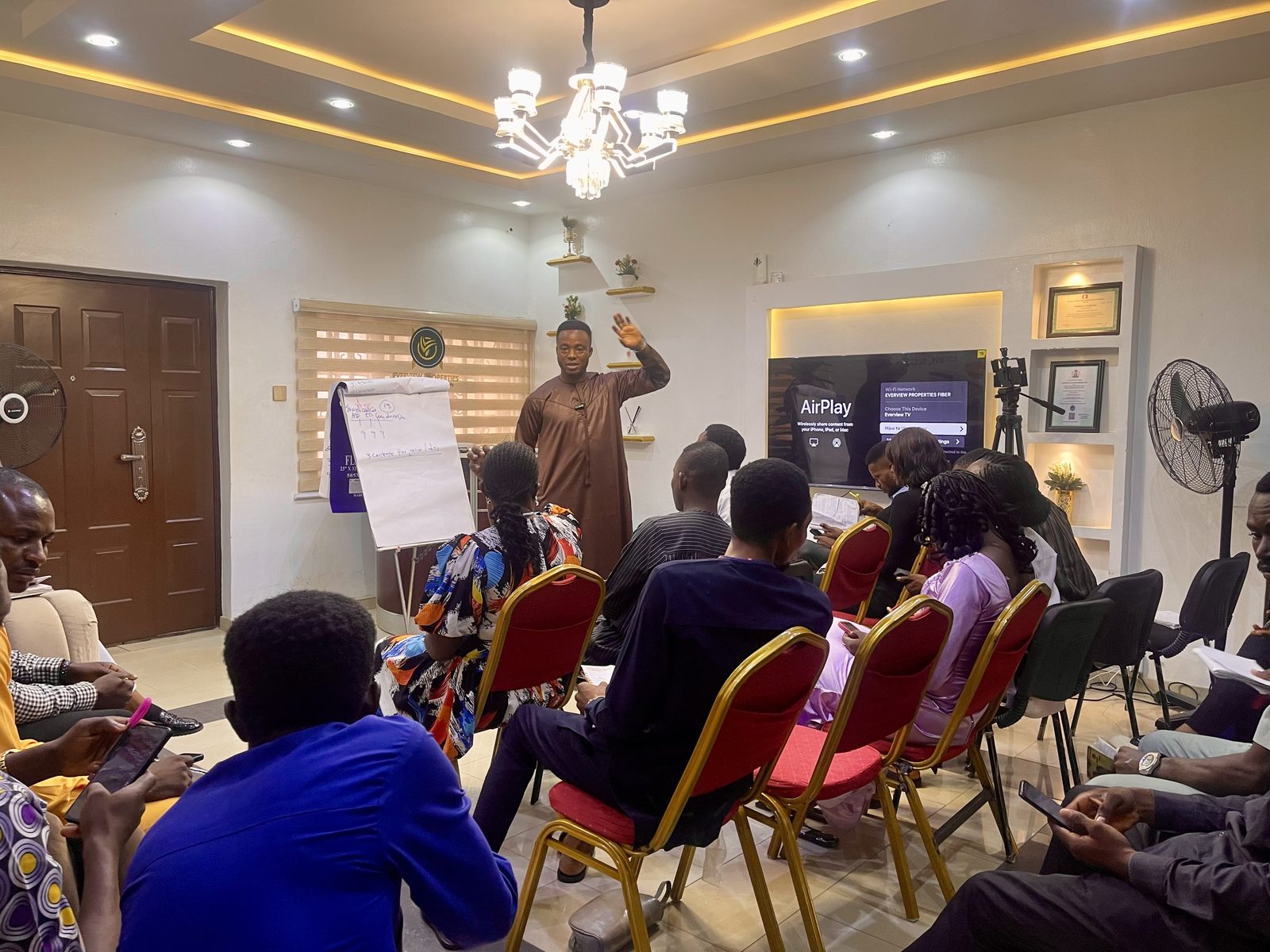 Tion Joseph teaching a full class the paid advertising funnel on a whiteboard