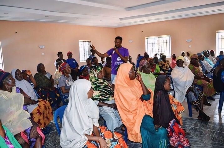 Tion Joseph speaking to a large community audience on digital skills in Nigeria