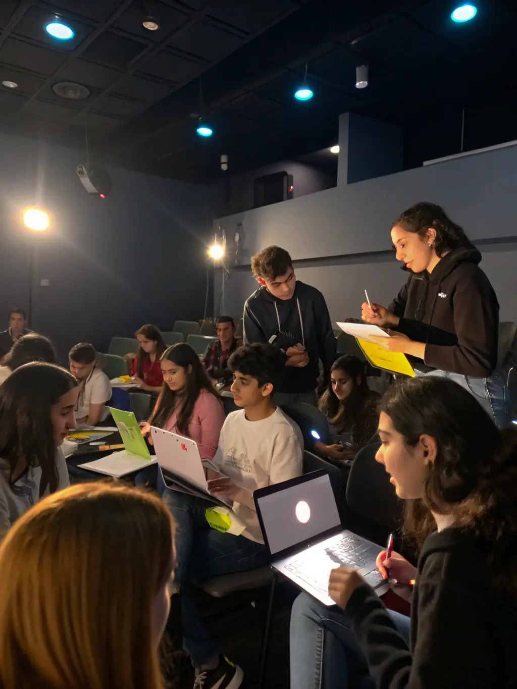 A group of diverse students actively participating in a digital marketing workshop, with laptops and engaging in a discussion, showcasing the interactive learning environment.